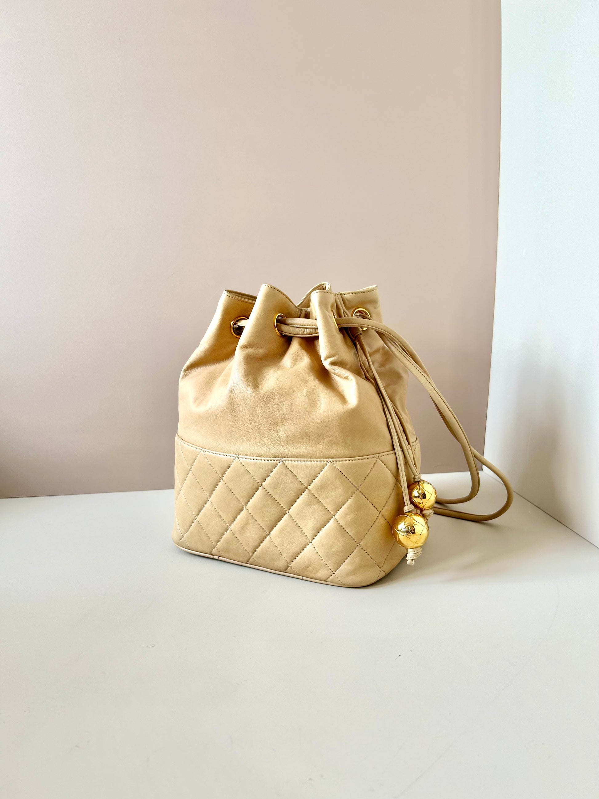 CHANEL rare beige lambskin double gold ball drawstring small bucket / side bag