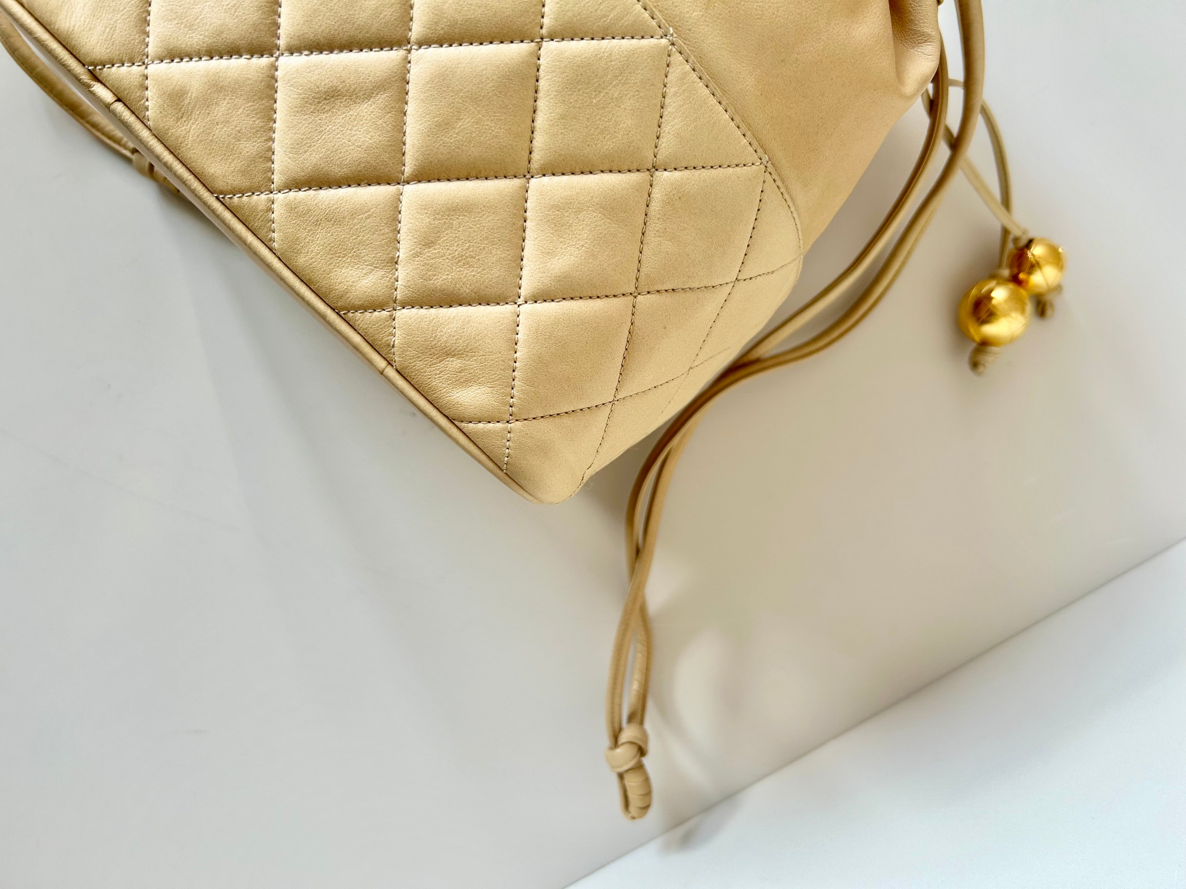 CHANEL rare beige lambskin double gold ball drawstring small bucket / side bag