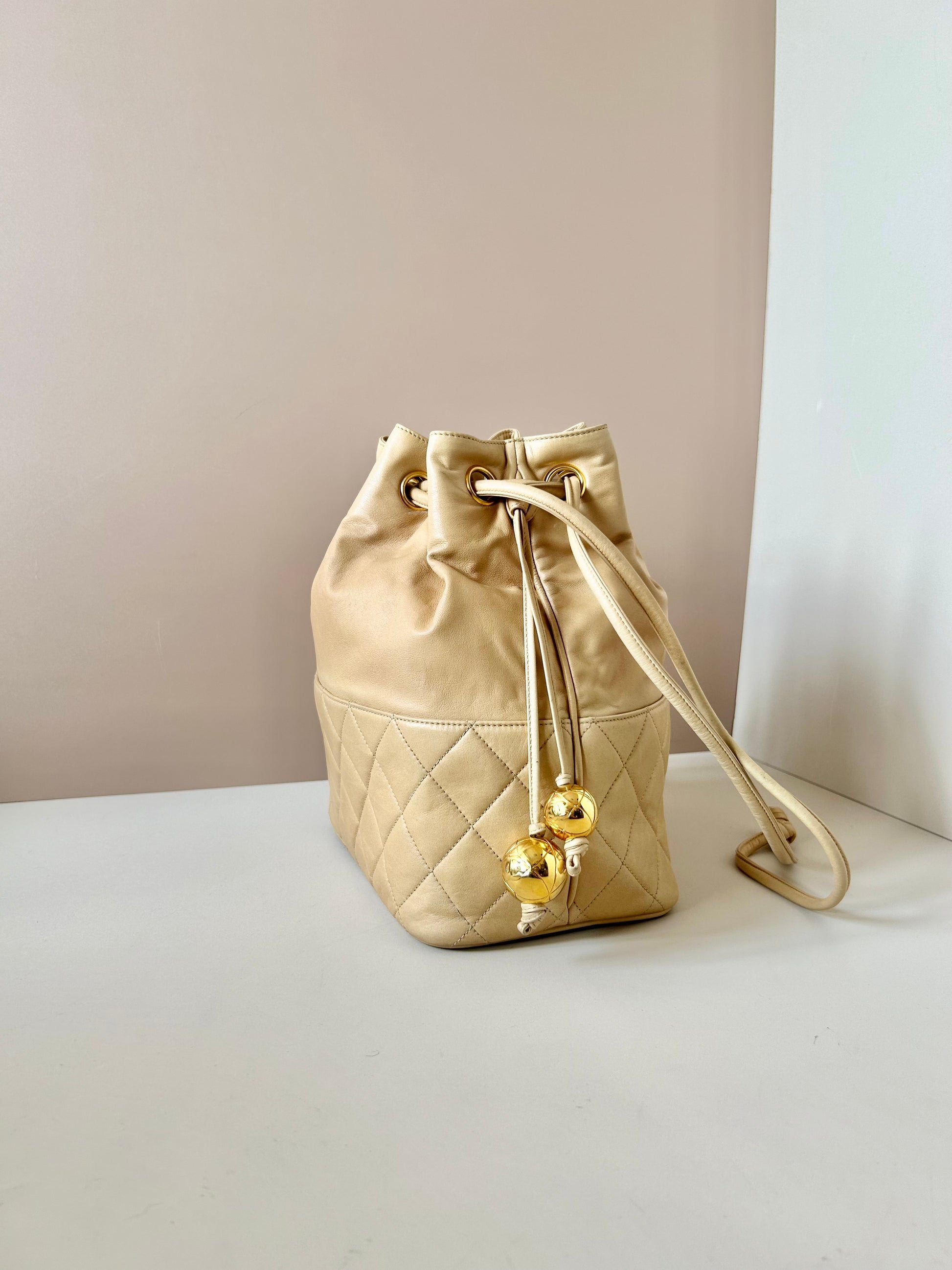 CHANEL rare beige lambskin double gold ball drawstring small bucket / side bag