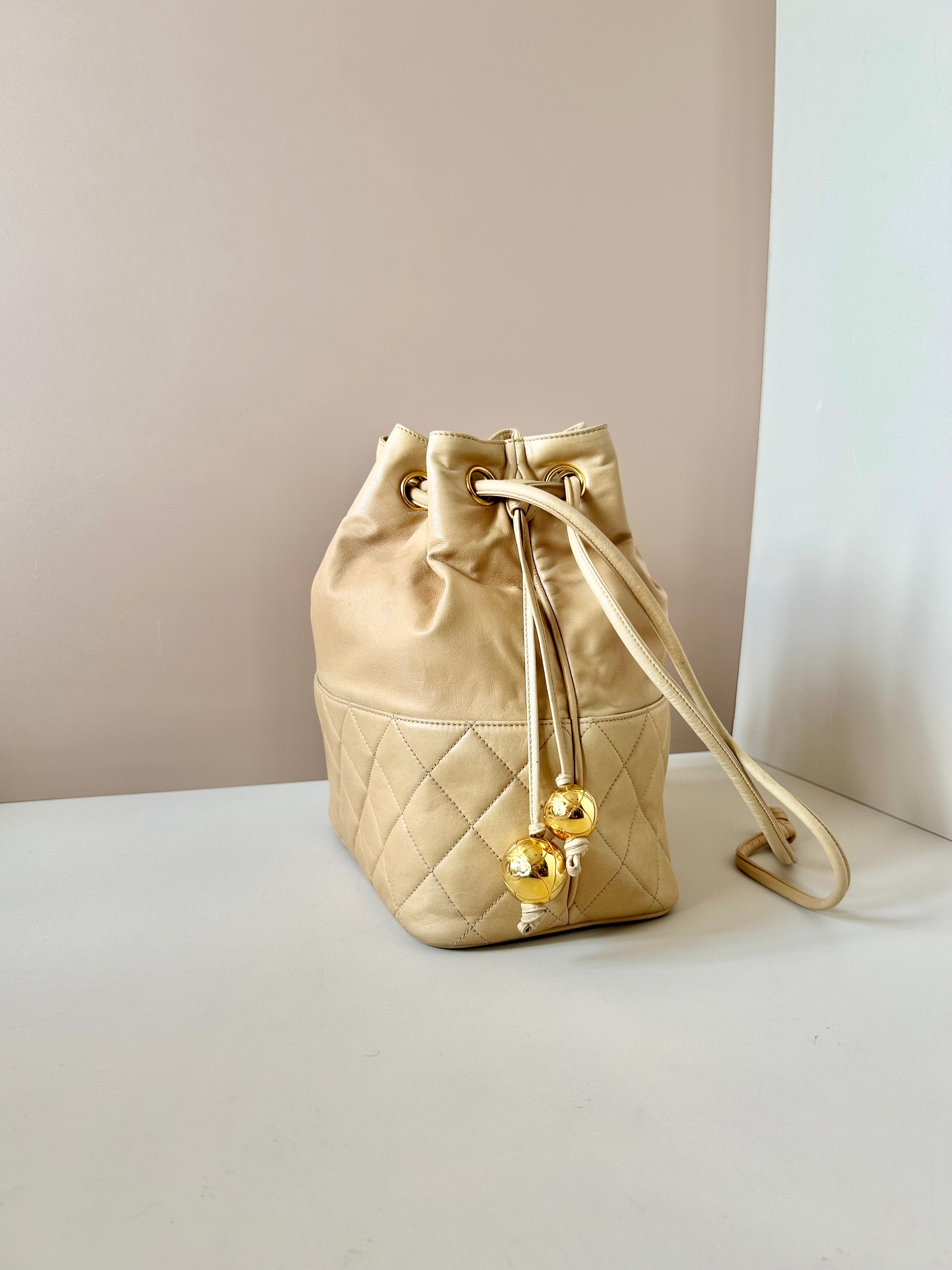 CHANEL rare beige lambskin double gold ball drawstring small bucket / side bag