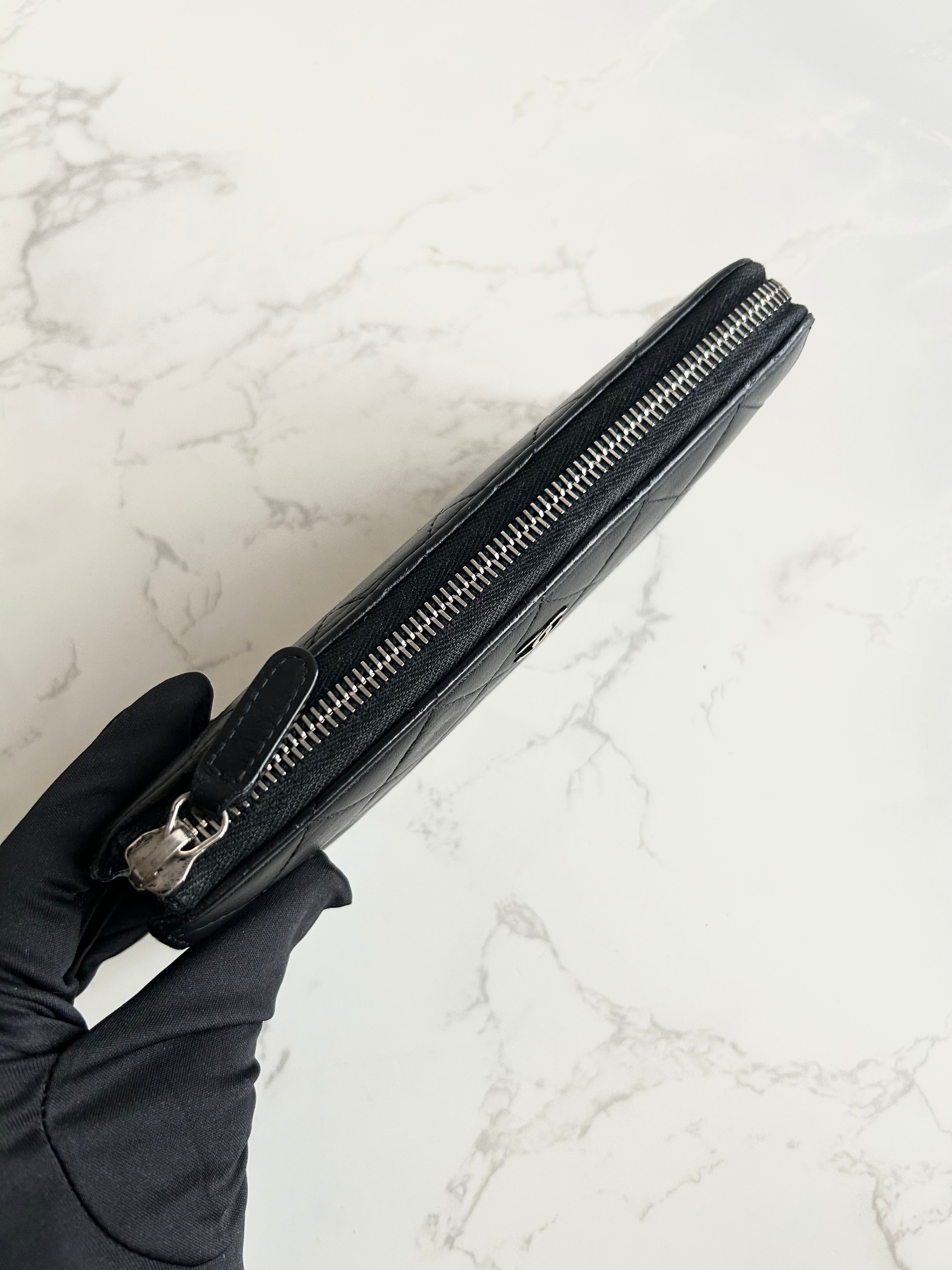 Recent season Chanel black and gold lambskin long wallet