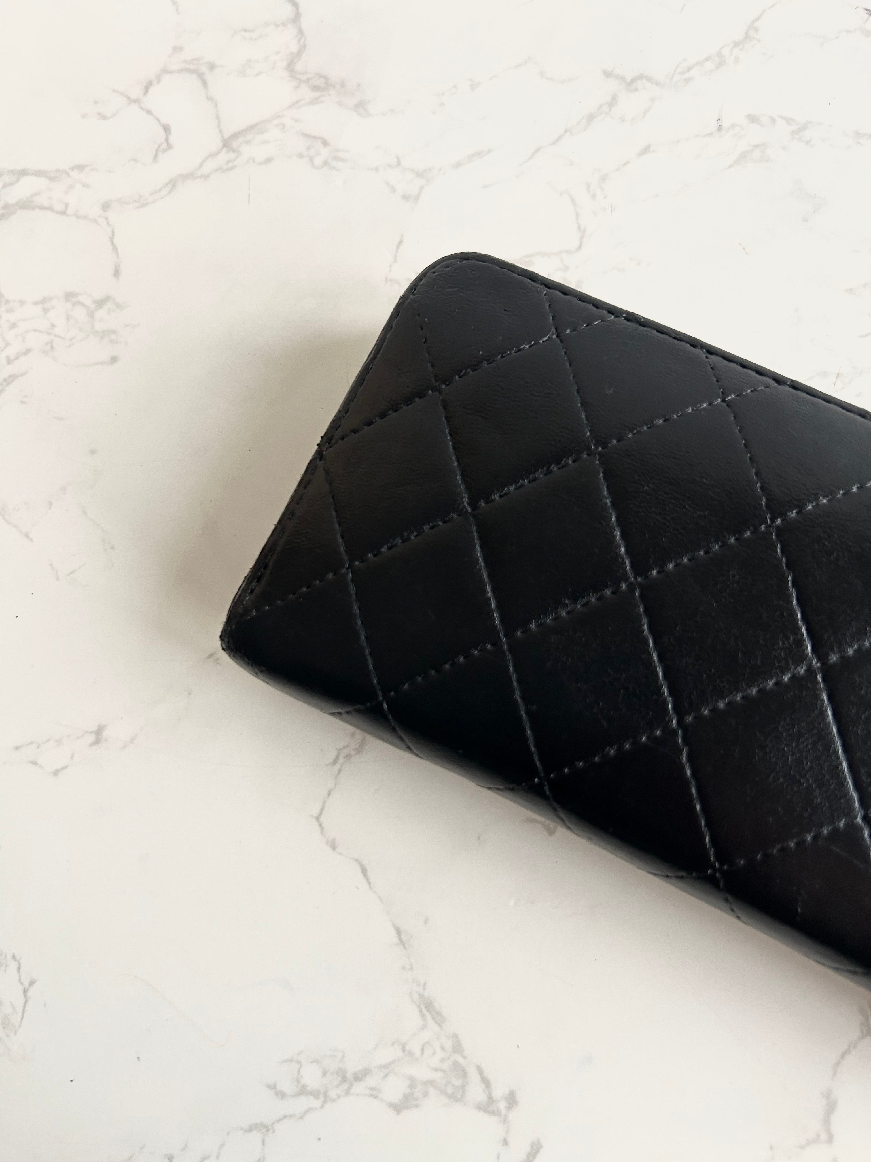 Recent season Chanel black and gold lambskin long wallet
