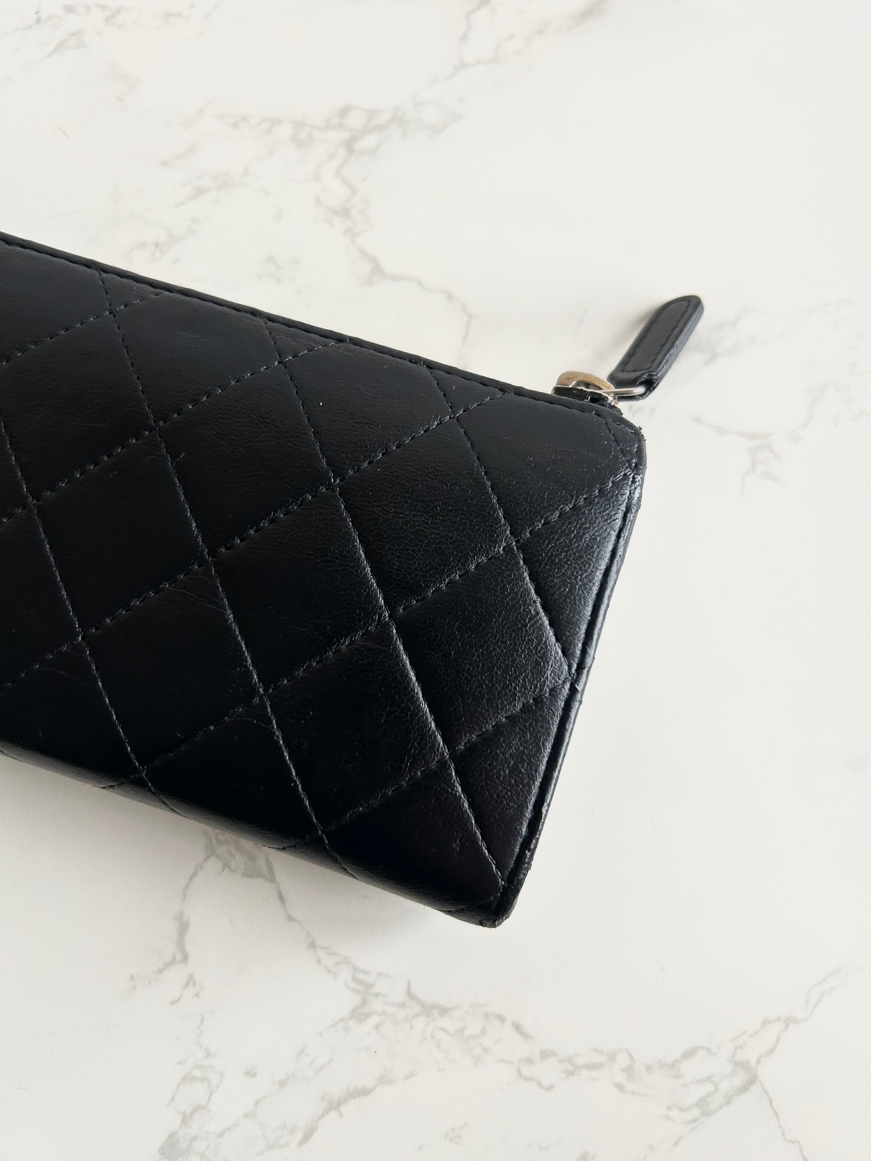Recent season Chanel black and gold lambskin long wallet