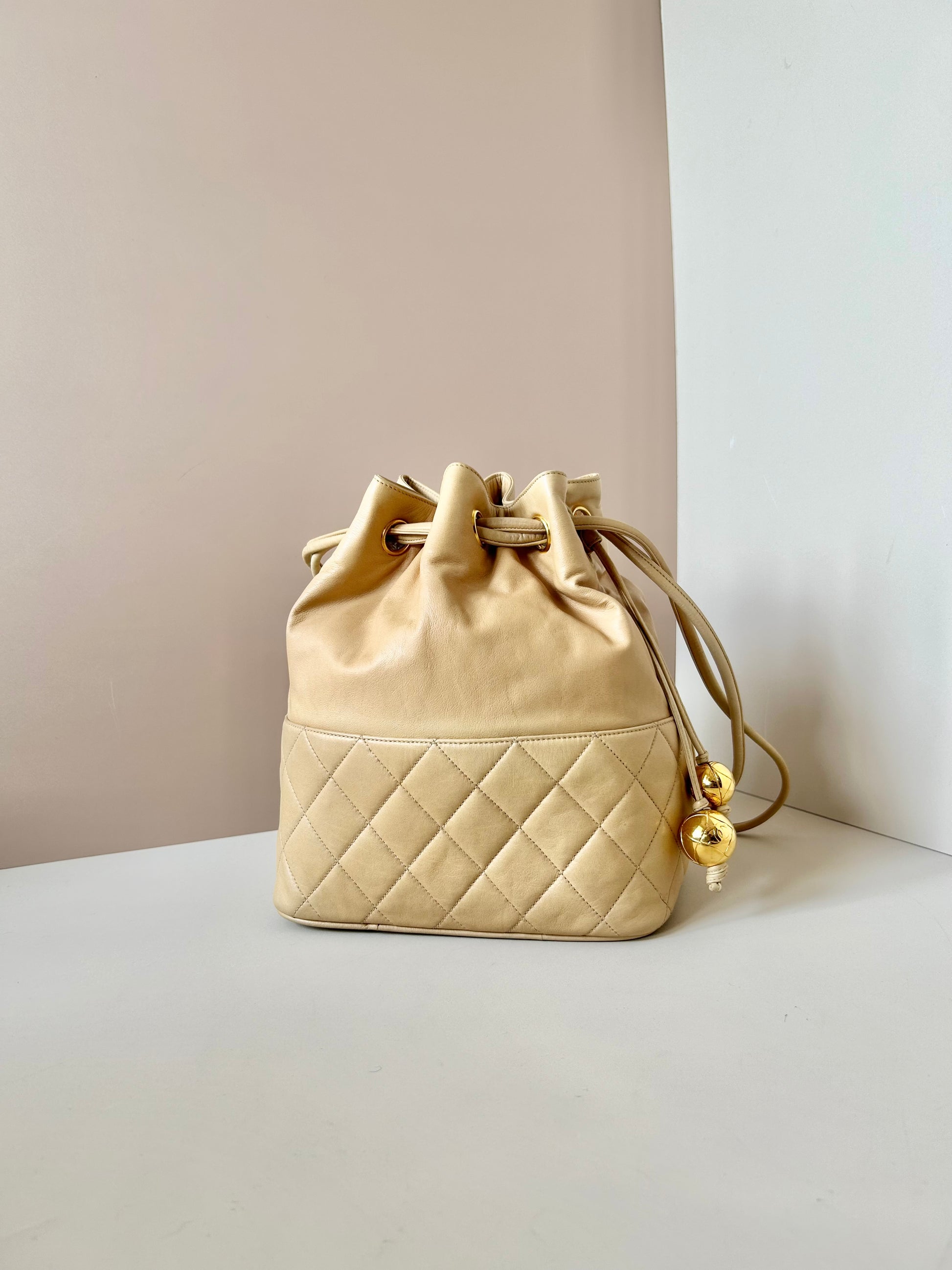 CHANEL rare beige lambskin double gold ball drawstring small bucket / side bag