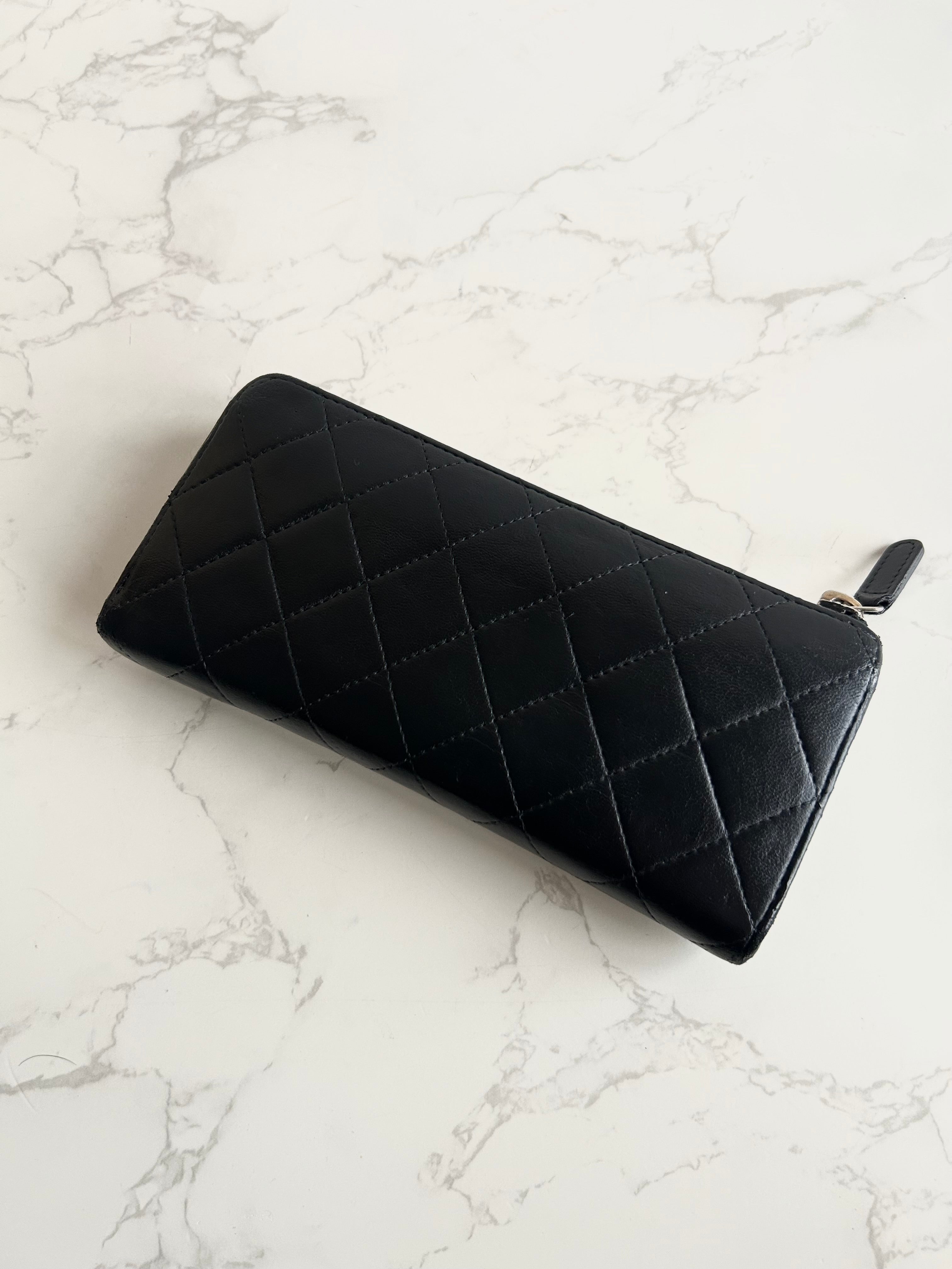 Recent season Chanel black and gold lambskin long wallet