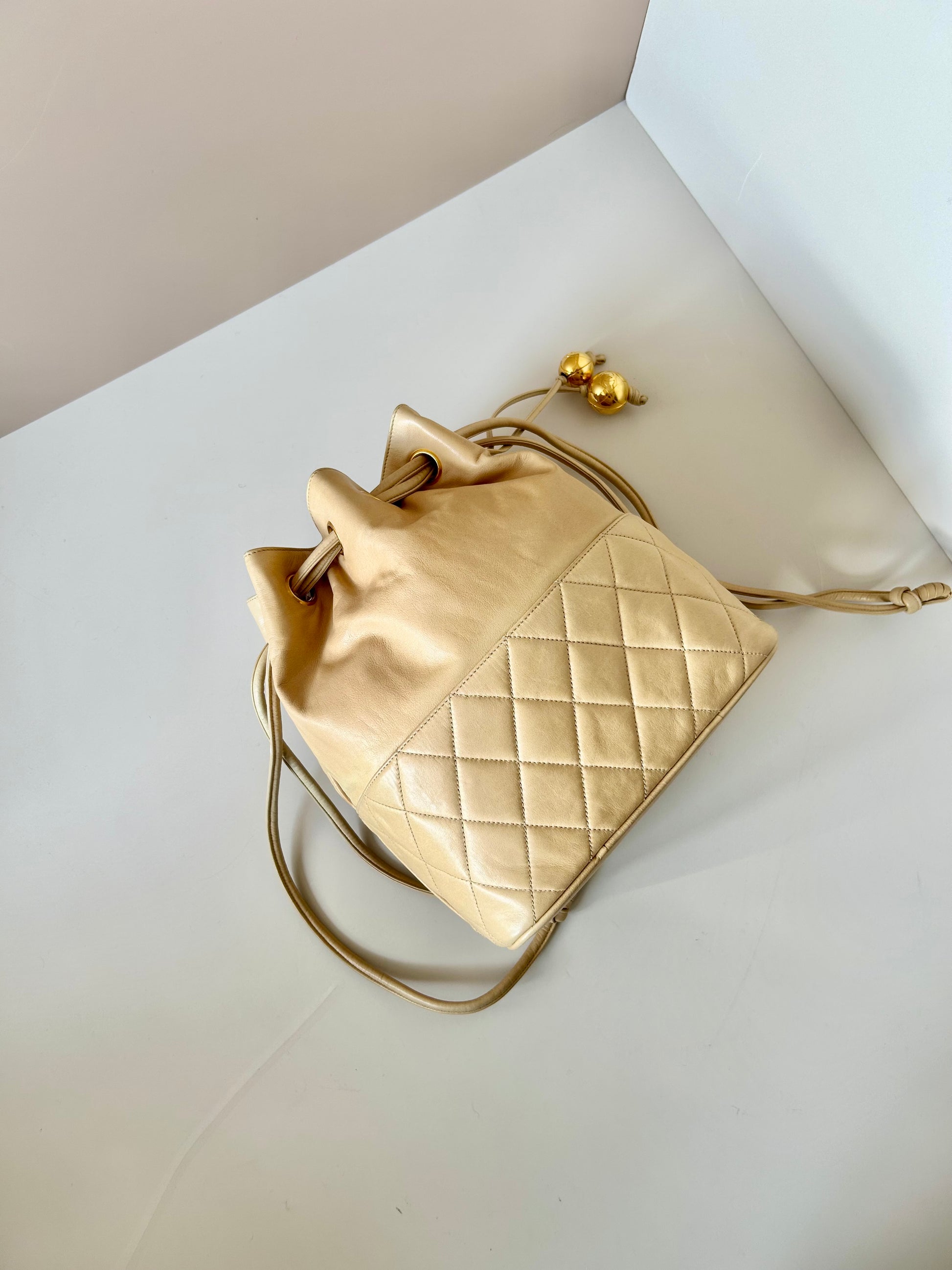 CHANEL rare beige lambskin double gold ball drawstring small bucket / side bag