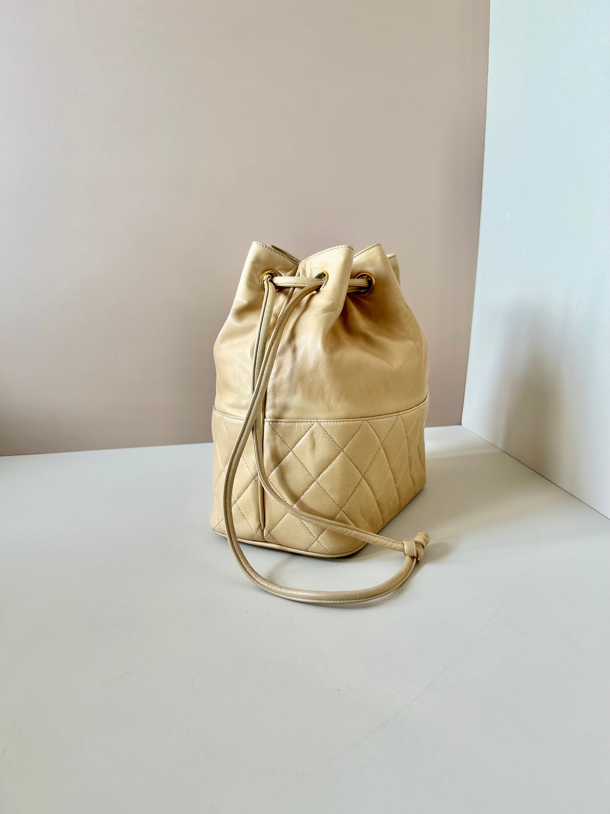 CHANEL rare beige lambskin double gold ball drawstring small bucket / side bag
